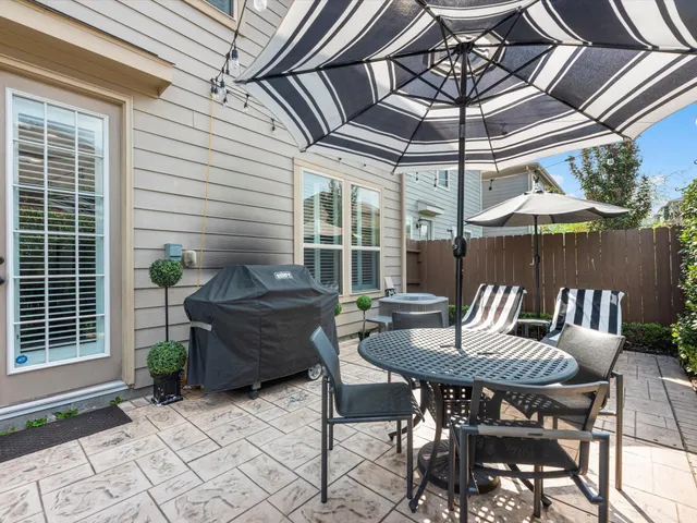 a patio with a table and chairs