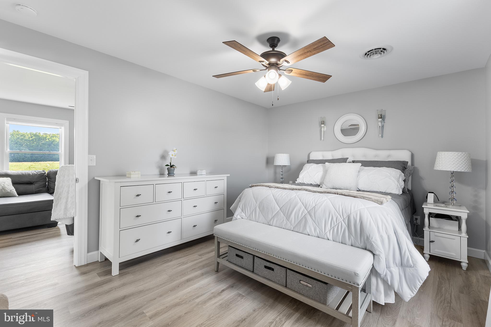 25485 Hignutt Road Denton, MD 21629 - Photo 22 of 52 a bedroom with a bed and a chandelier