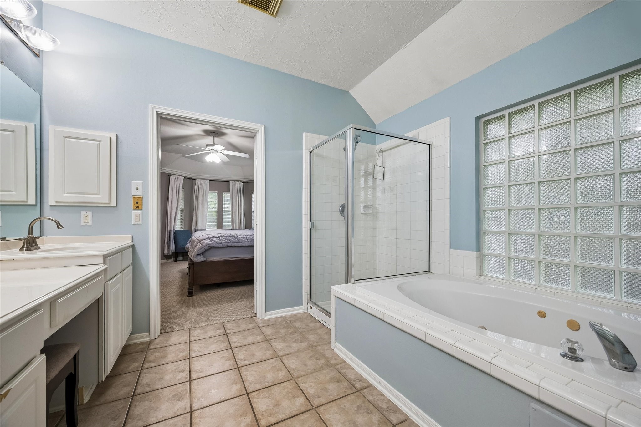 8123 Clarion Way Houston, TX 77040 - Photo 21 of 33 a bathroom with a tub a sink and a large mirror