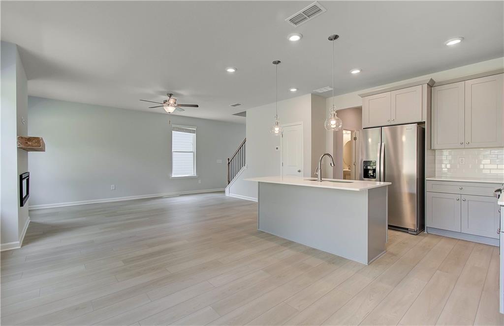 117 Alpine Road Fairburn, GA 30213 - Photo 13 of 29 a large kitchen with a refrigerator a counter top space and stainless steel appliances
