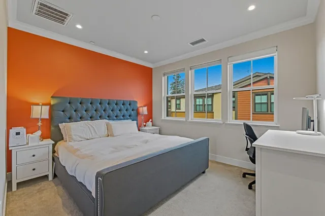 a bedroom with a bed and a lamp