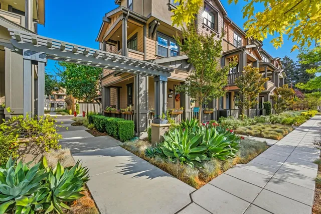 a view of a house with potted plants