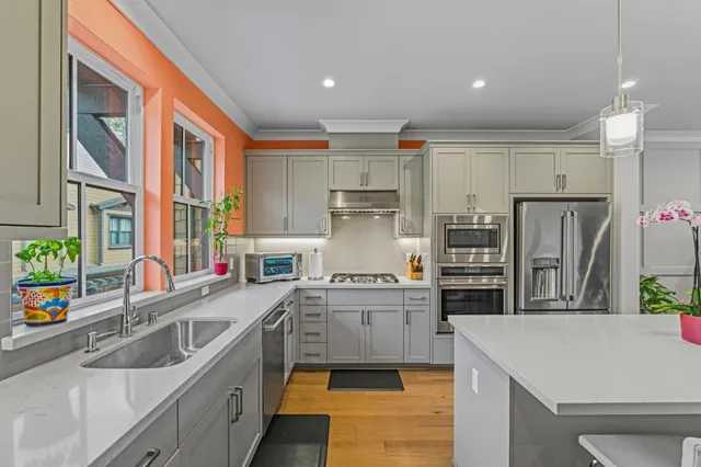 a kitchen with a table chairs refrigerator and microwave
