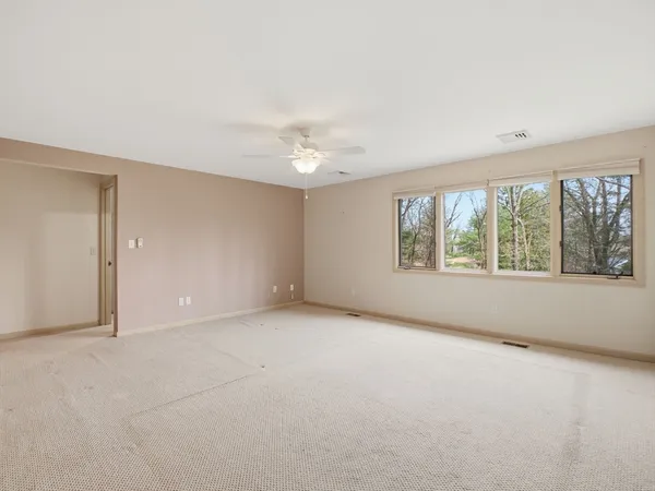 an empty room with windows and view of an empty room