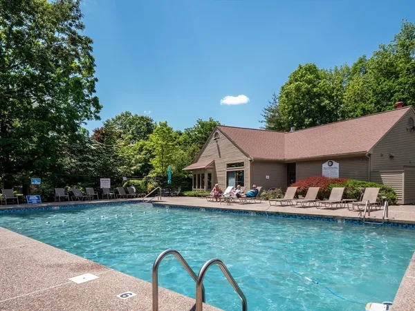 a backyard of a house with yard table and chairs