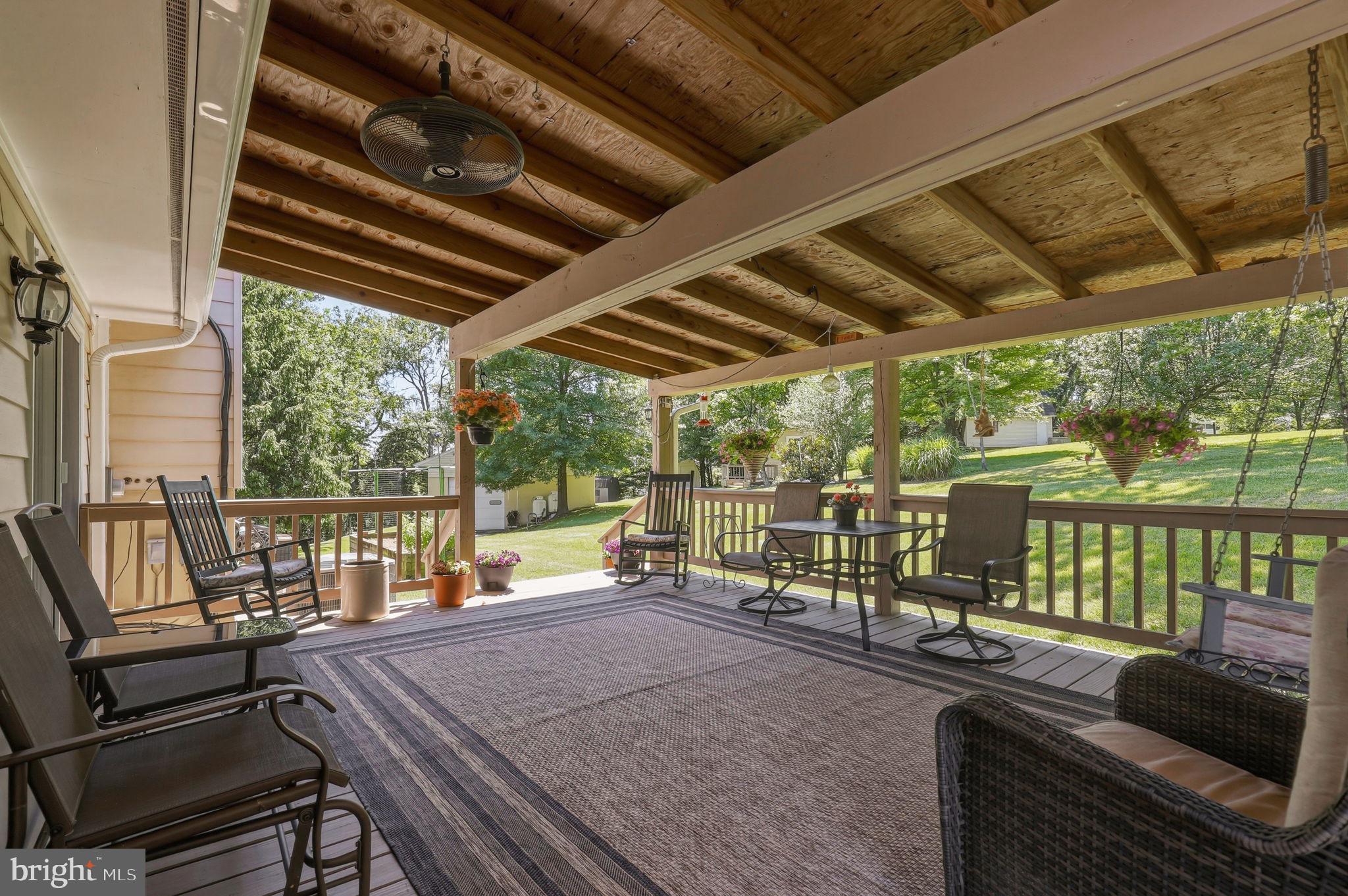 6336 Boyers Mill Road New Market, MD 21774 - Photo 36 of 49 a view of a patio with table and chairs with wooden floor and fence