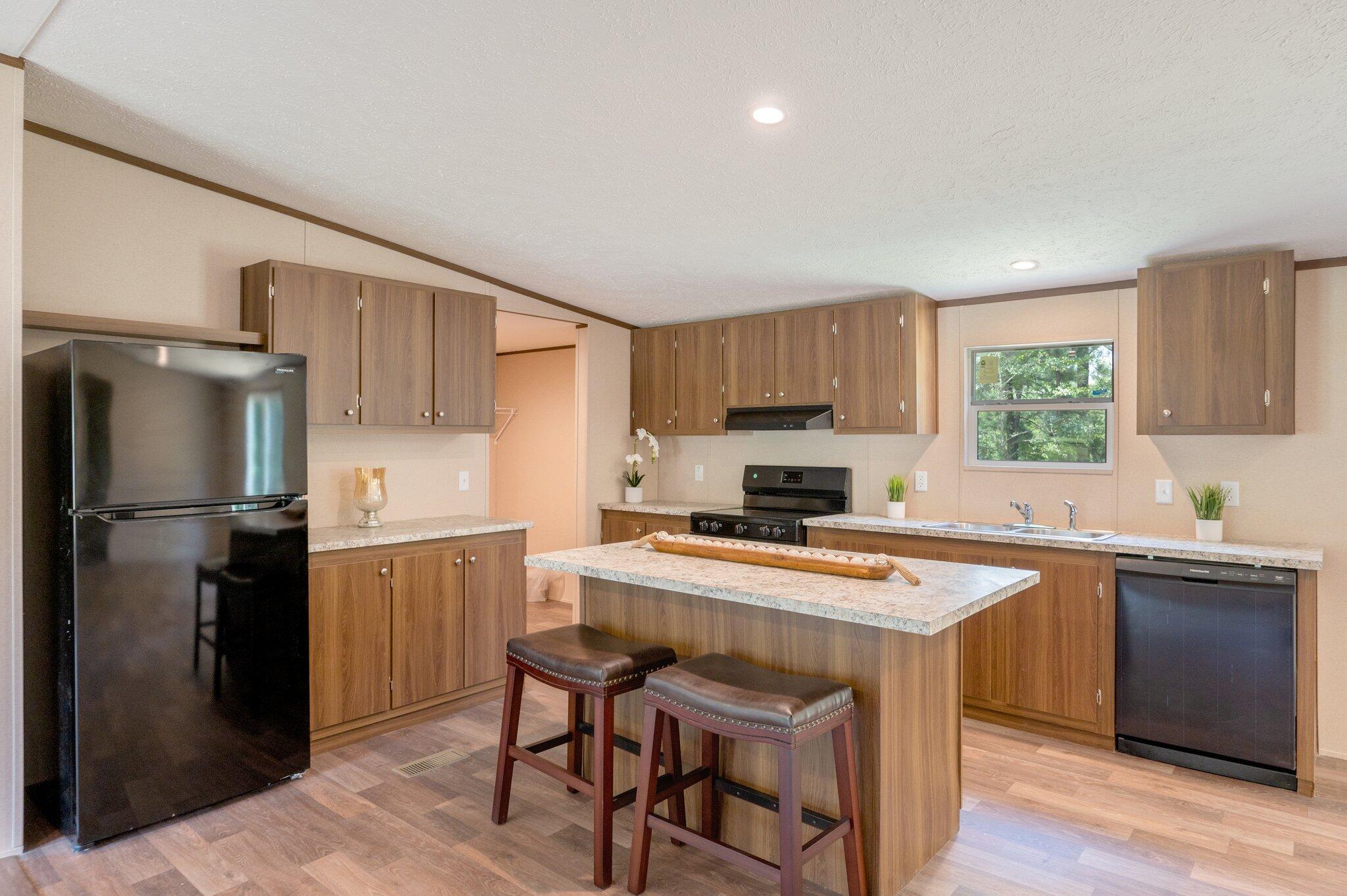 5227 Richardson Road Crestview, FL 32539 - Photo 11 of 44 a kitchen with a stove a refrigerator and a sink