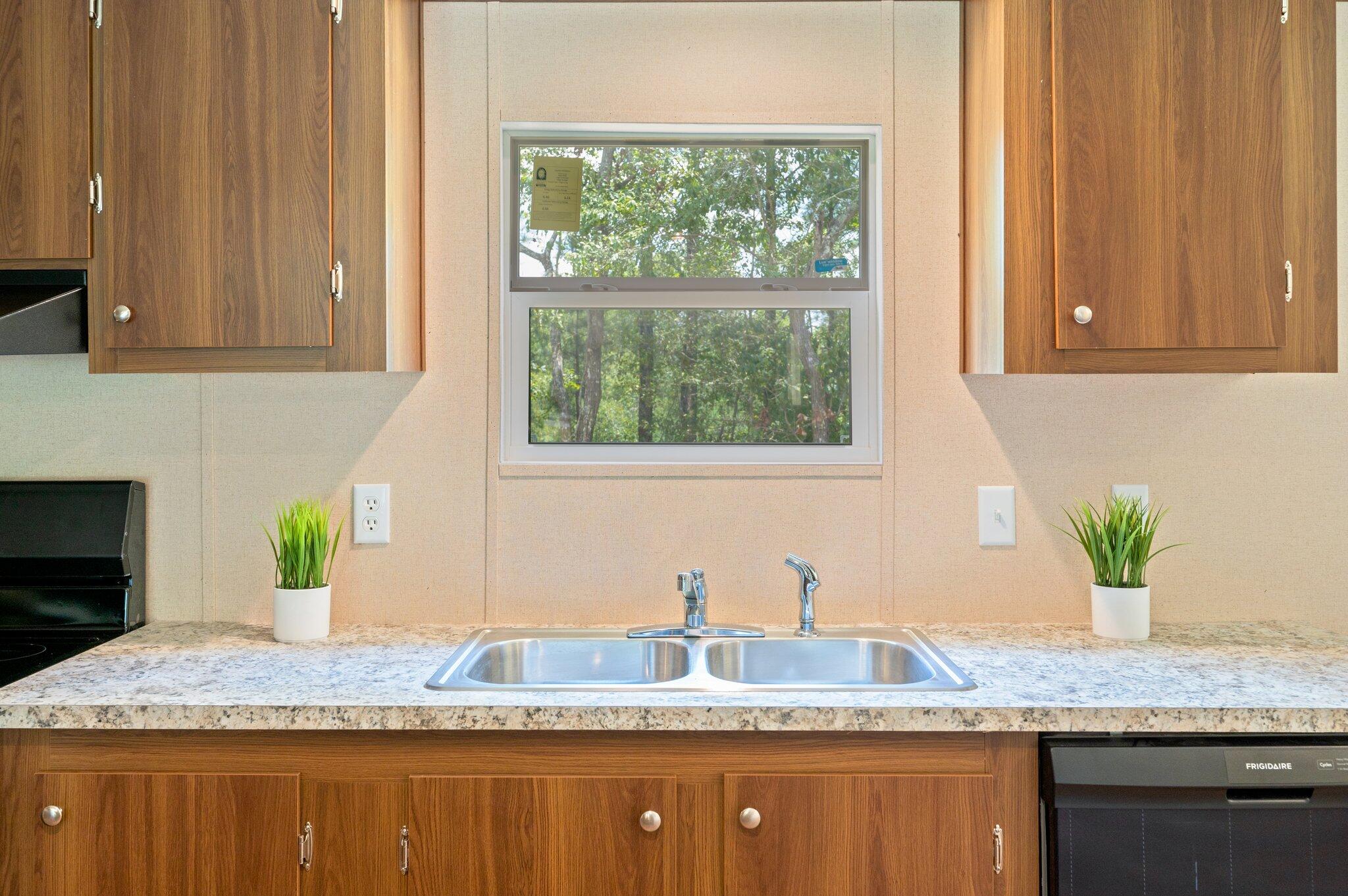 5227 Richardson Road Crestview, FL 32539 - Photo 14 of 44 a kitchen with granite countertop a sink stainless steel appliances and a window
