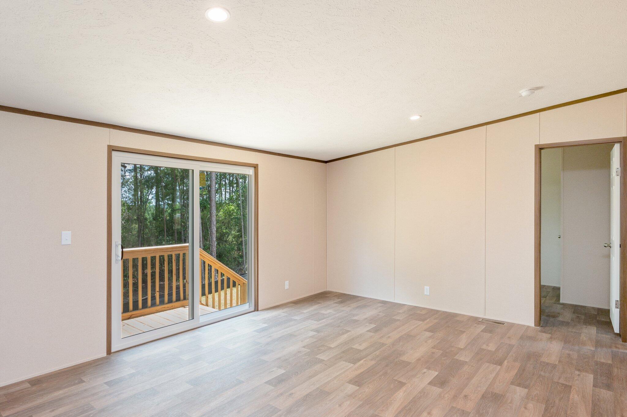 5227 Richardson Road Crestview, FL 32539 - Photo 17 of 44 a view of an empty room with wooden floor and a window