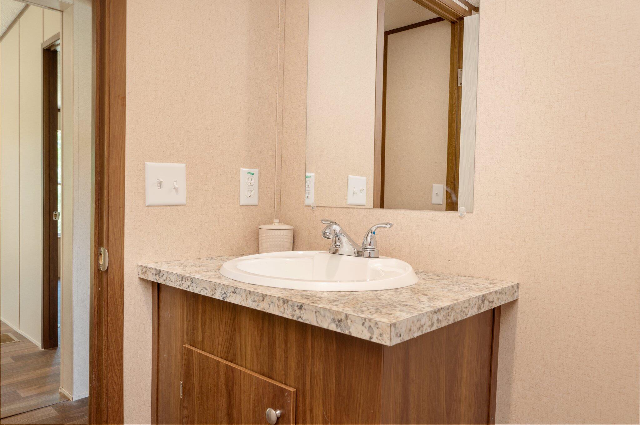 5227 Richardson Road Crestview, FL 32539 - Photo 31 of 44 a bathroom with a granite countertop sink and a mirror