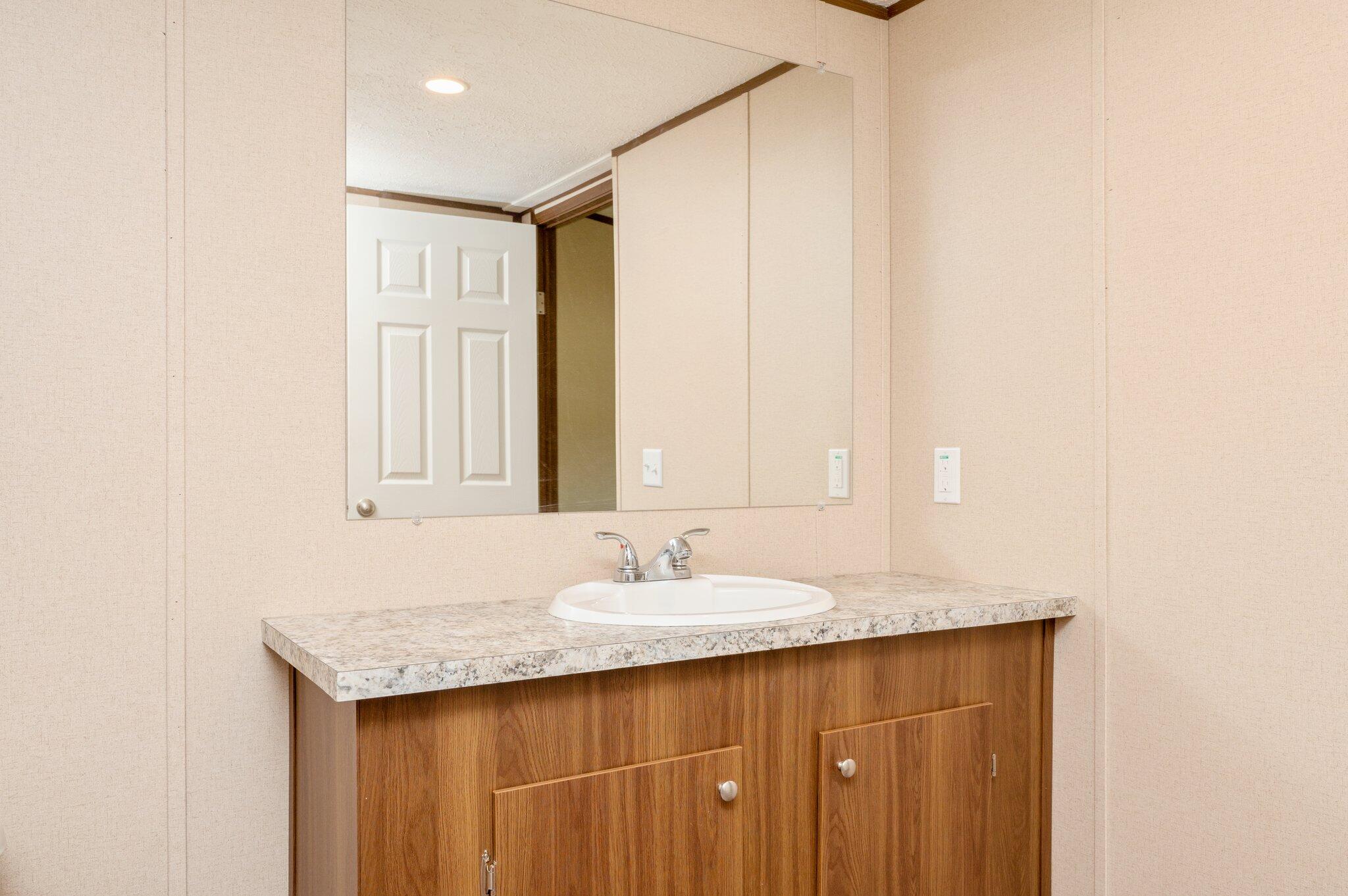 5227 Richardson Road Crestview, FL 32539 - Photo 32 of 44 a bathroom with a granite countertop sink and a mirror