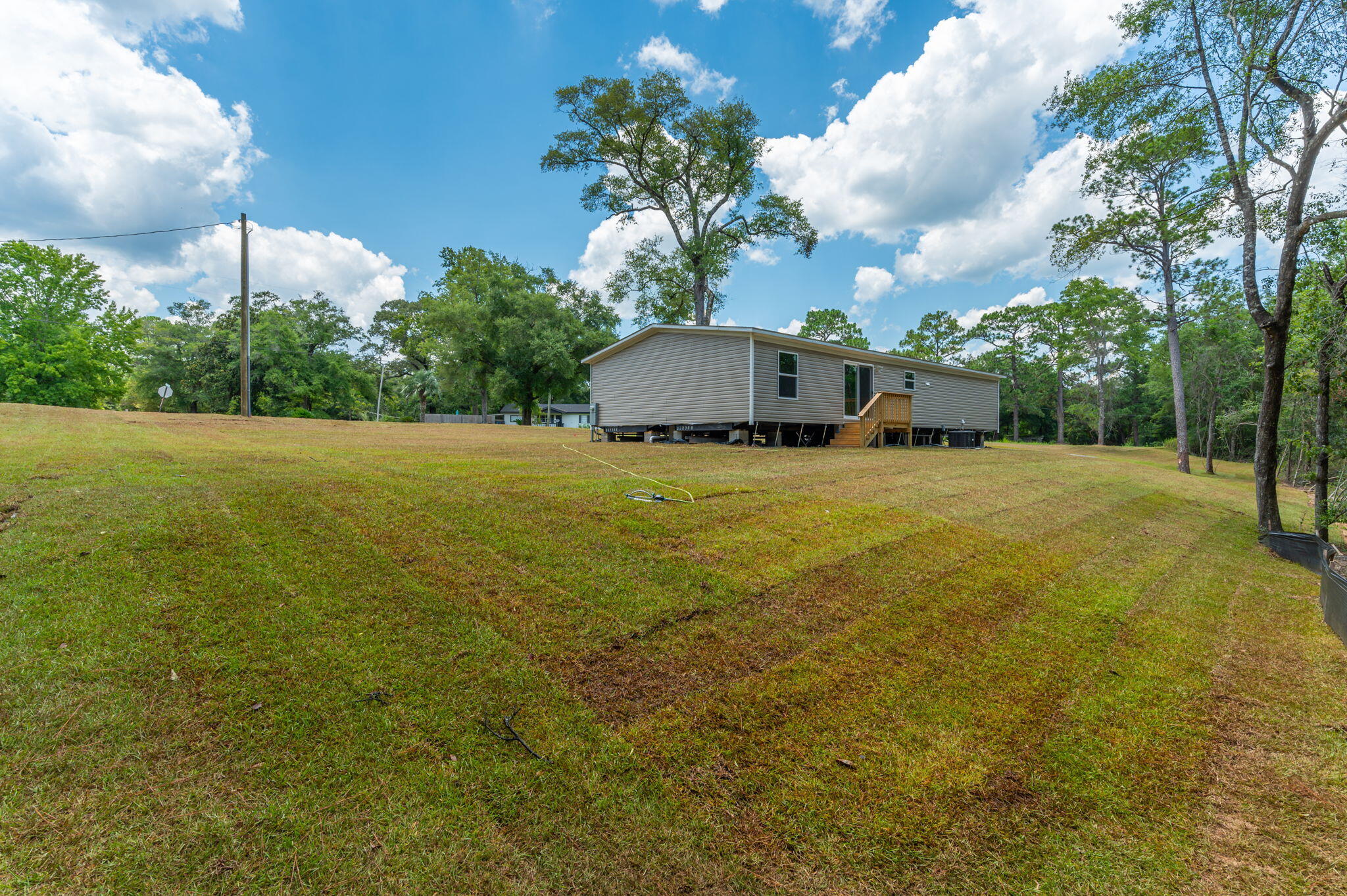 5227 Richardson Road Crestview, FL 32539 - Photo 36 of 44 a view of a yard with a house in the background