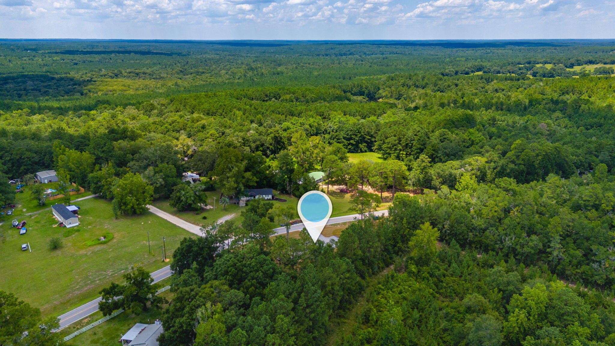 5227 Richardson Road Crestview, FL 32539 - Photo 41 of 44 a backyard of a house with lots of green space and lake view
