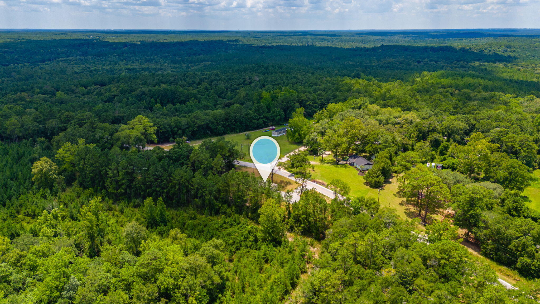 5227 Richardson Road Crestview, FL 32539 - Photo 42 of 44 a aerial view of a house with a yard and lake view