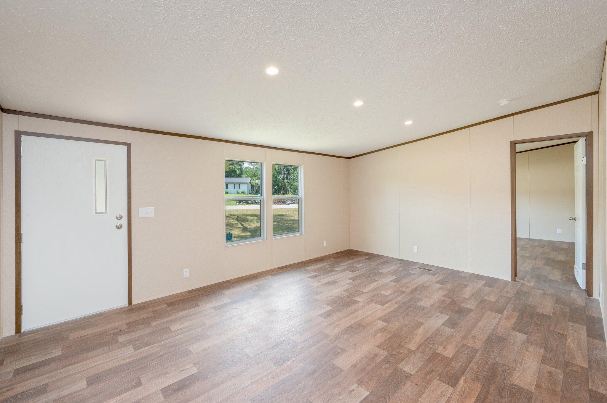 5227 Richardson Road Crestview, FL 32539 - Photo 8 of 44 a view of an empty room with wooden floor and a window