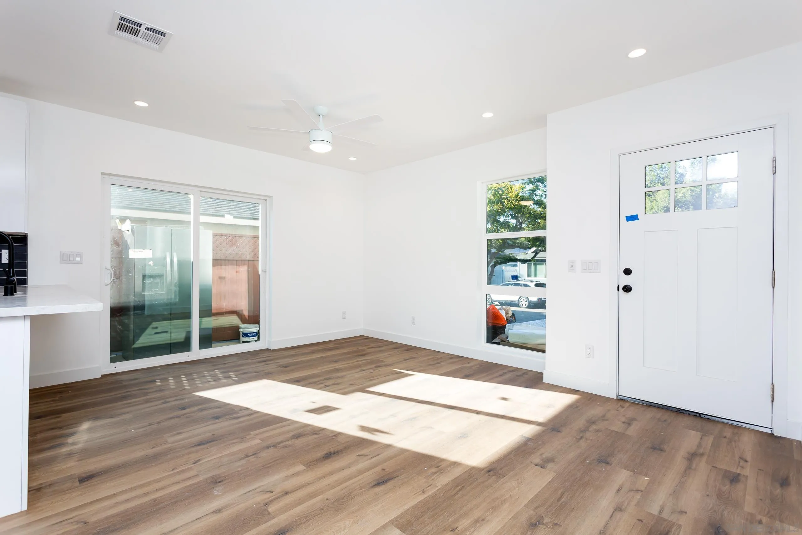 5721-23 Campanile Way San Diego, CA 92115 - Photo 12 of 59 a view of a big room with wooden floor and windows