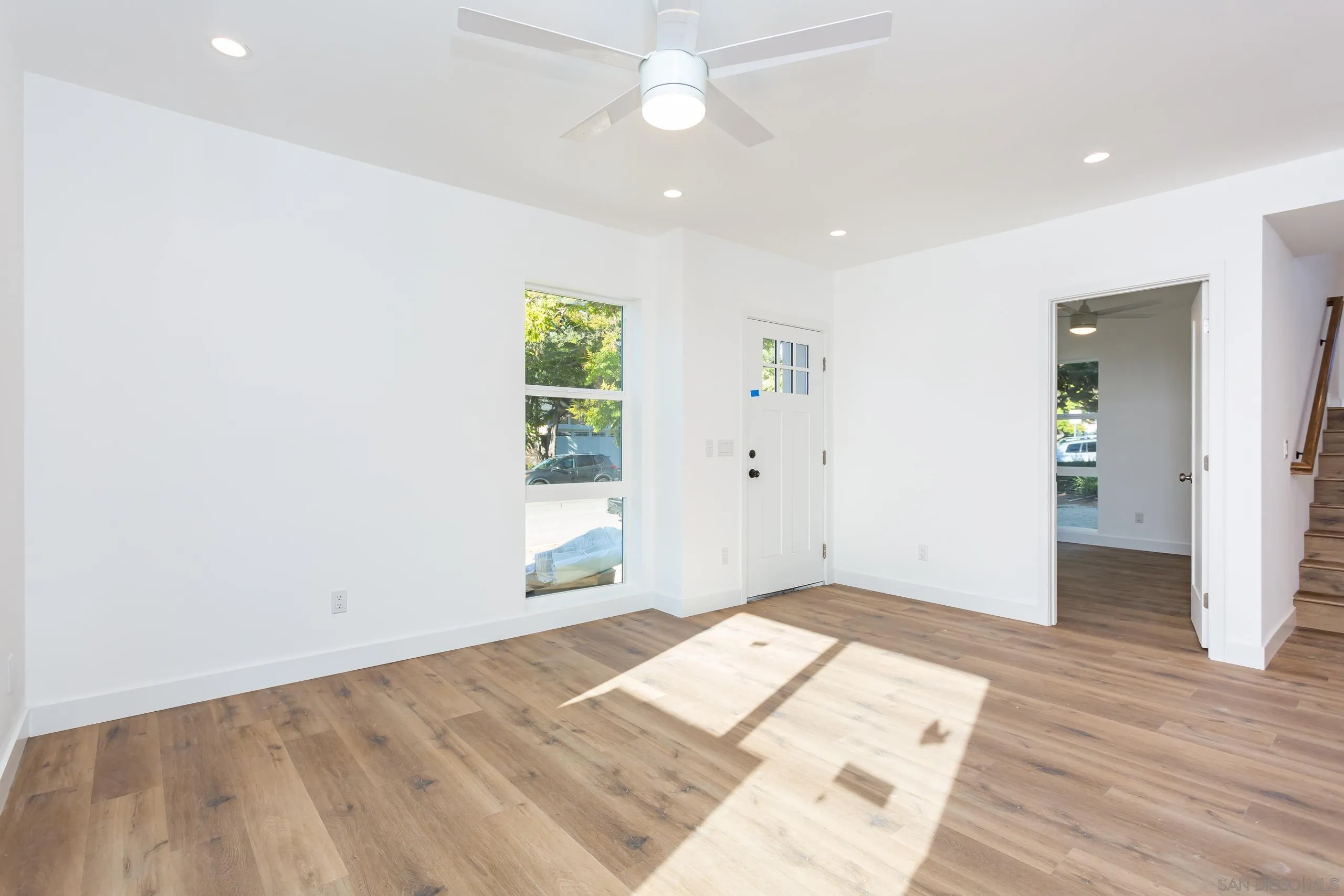 5721-23 Campanile Way San Diego, CA 92115 - Photo 13 of 59 wooden floor in an empty room with a window