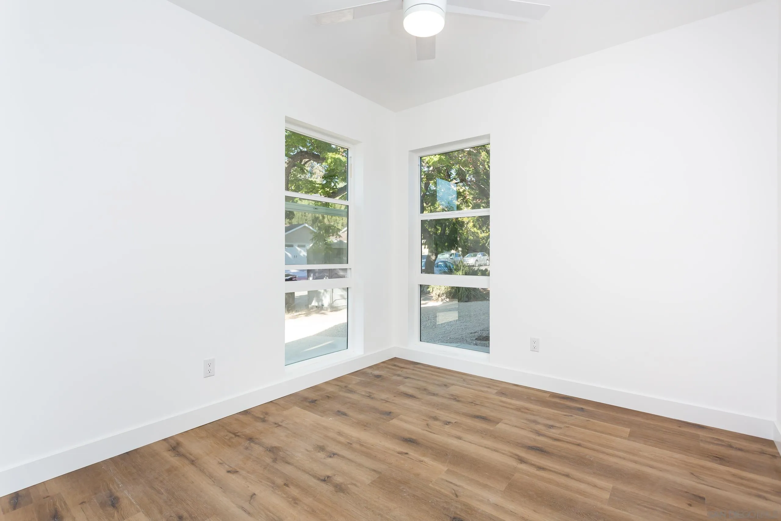 5721-23 Campanile Way San Diego, CA 92115 - Photo 14 of 59 an empty room with wooden floor and windows