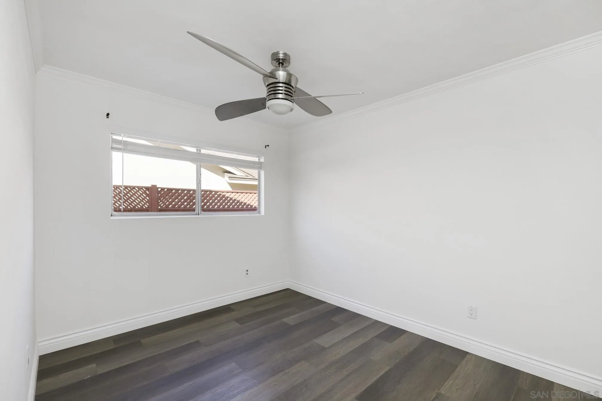5721-23 Campanile Way San Diego, CA 92115 - Photo 28 of 59 an empty room with a wooden floor and windows