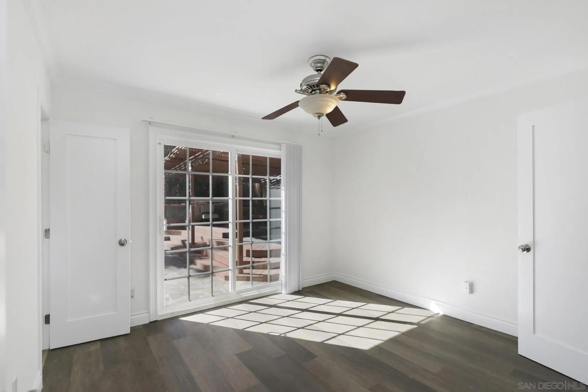 5721-23 Campanile Way San Diego, CA 92115 - Photo 30 of 59 a view of empty room with wooden floor and fan