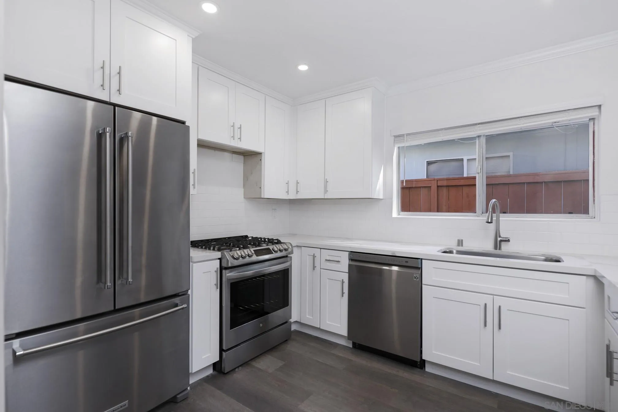 5721-23 Campanile Way San Diego, CA 92115 - Photo 41 of 59 a kitchen with a stove sink and refrigerator