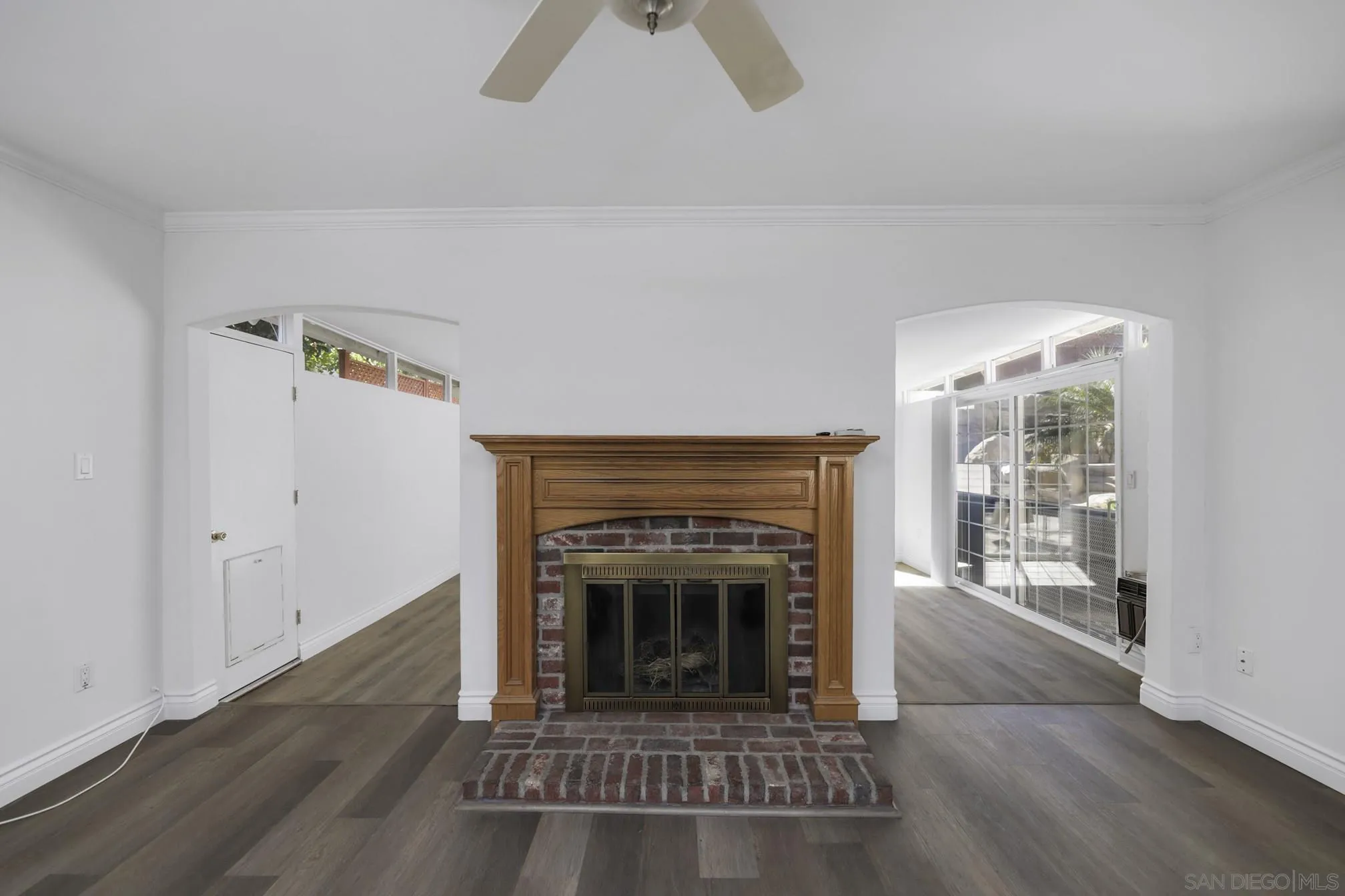 5721-23 Campanile Way San Diego, CA 92115 - Photo 44 of 59 an empty room with fireplace and wooden floor