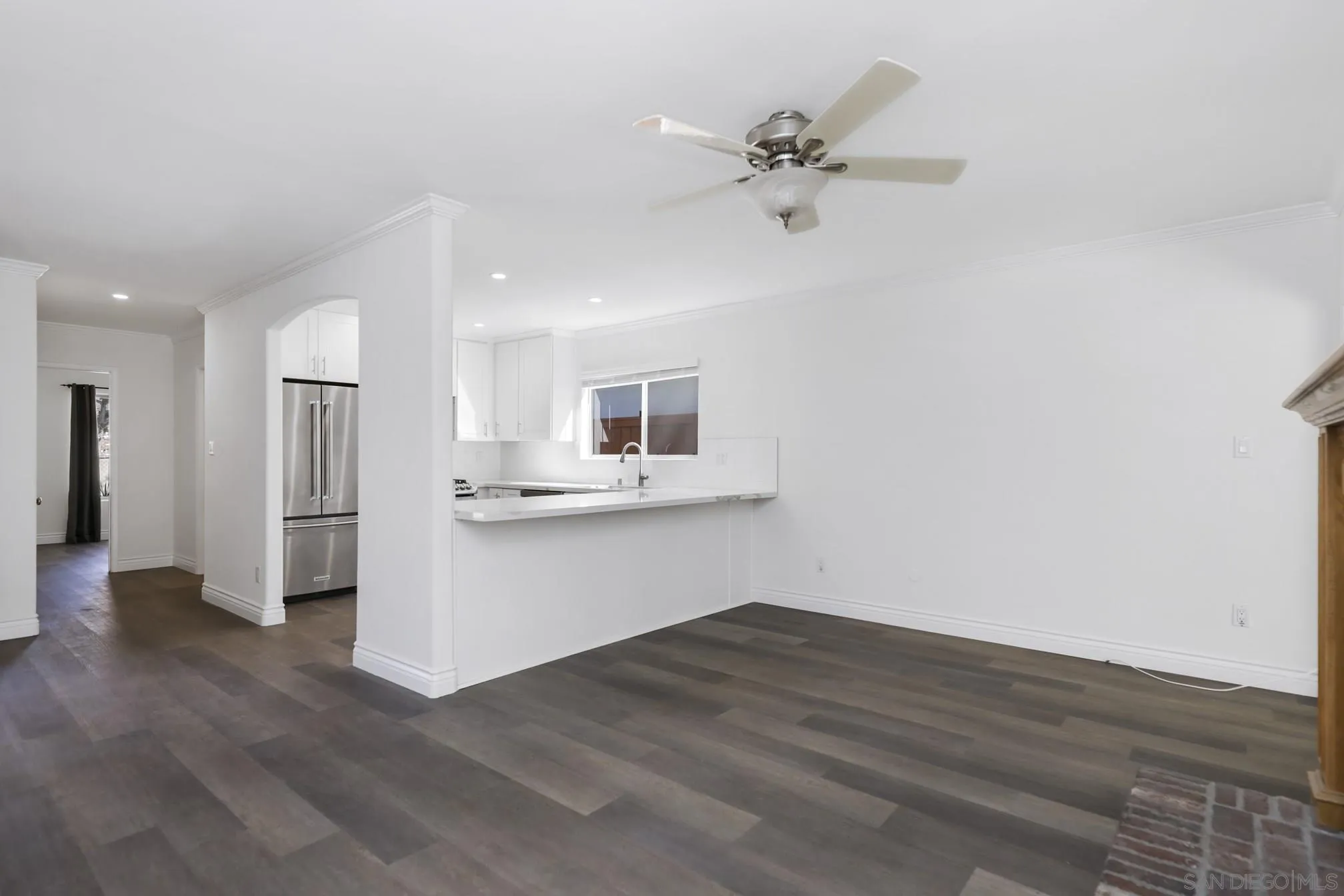 5721-23 Campanile Way San Diego, CA 92115 - Photo 45 of 59 a view of empty room with wooden floor and kitchen view