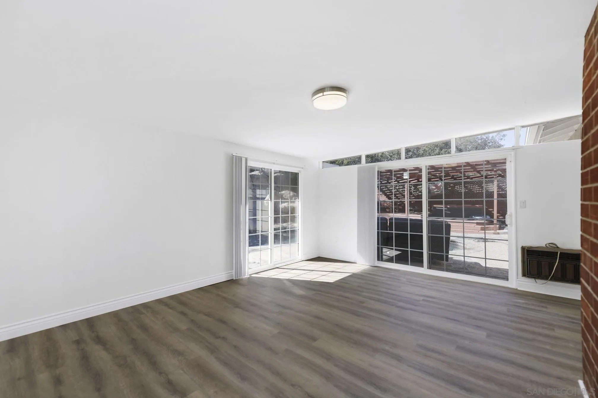 5721-23 Campanile Way San Diego, CA 92115 - Photo 47 of 59 an empty room with wooden floor and windows