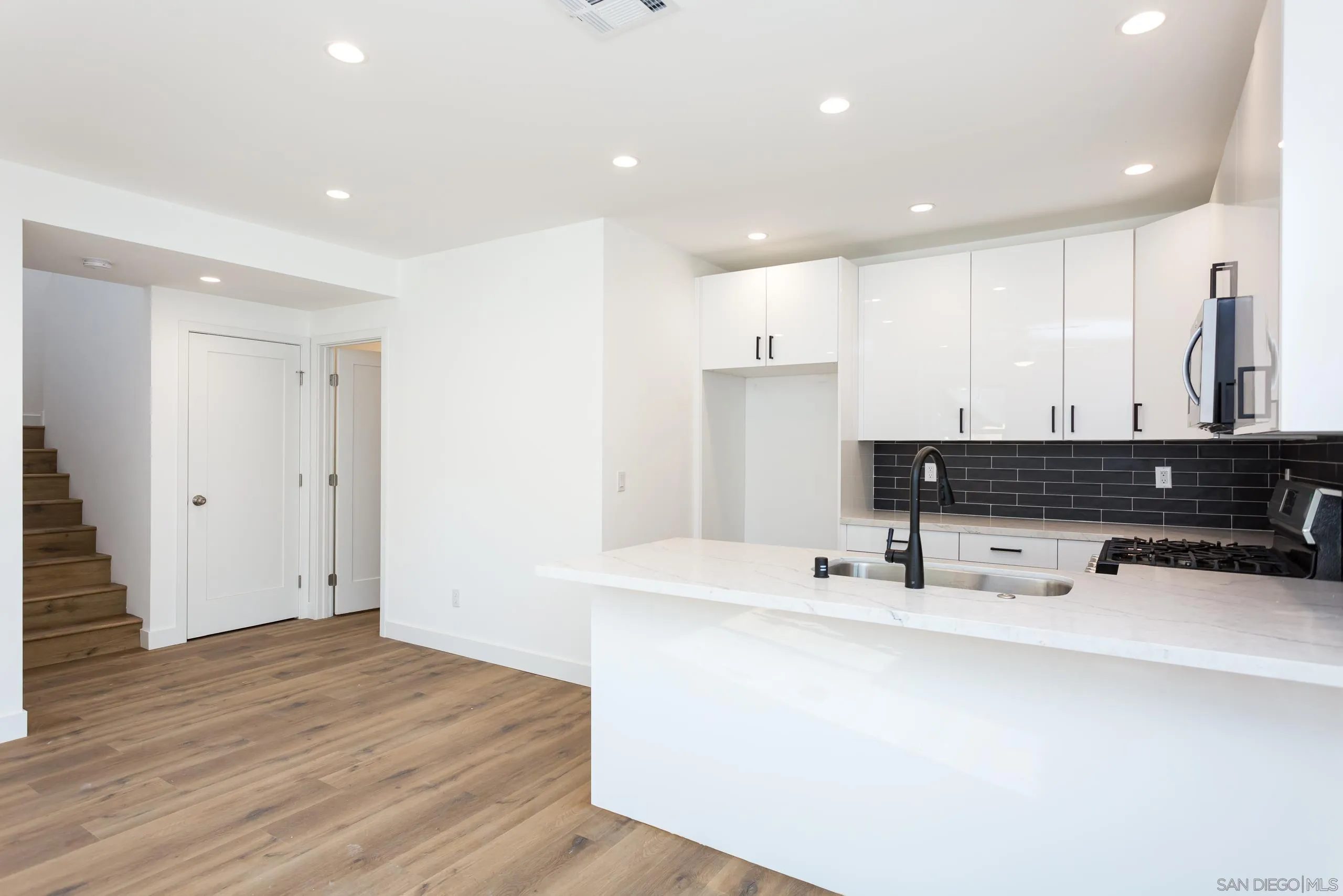 5721-23 Campanile Way San Diego, CA 92115 - Photo 5 of 59 a kitchen with stainless steel appliances a sink and a refrigerator