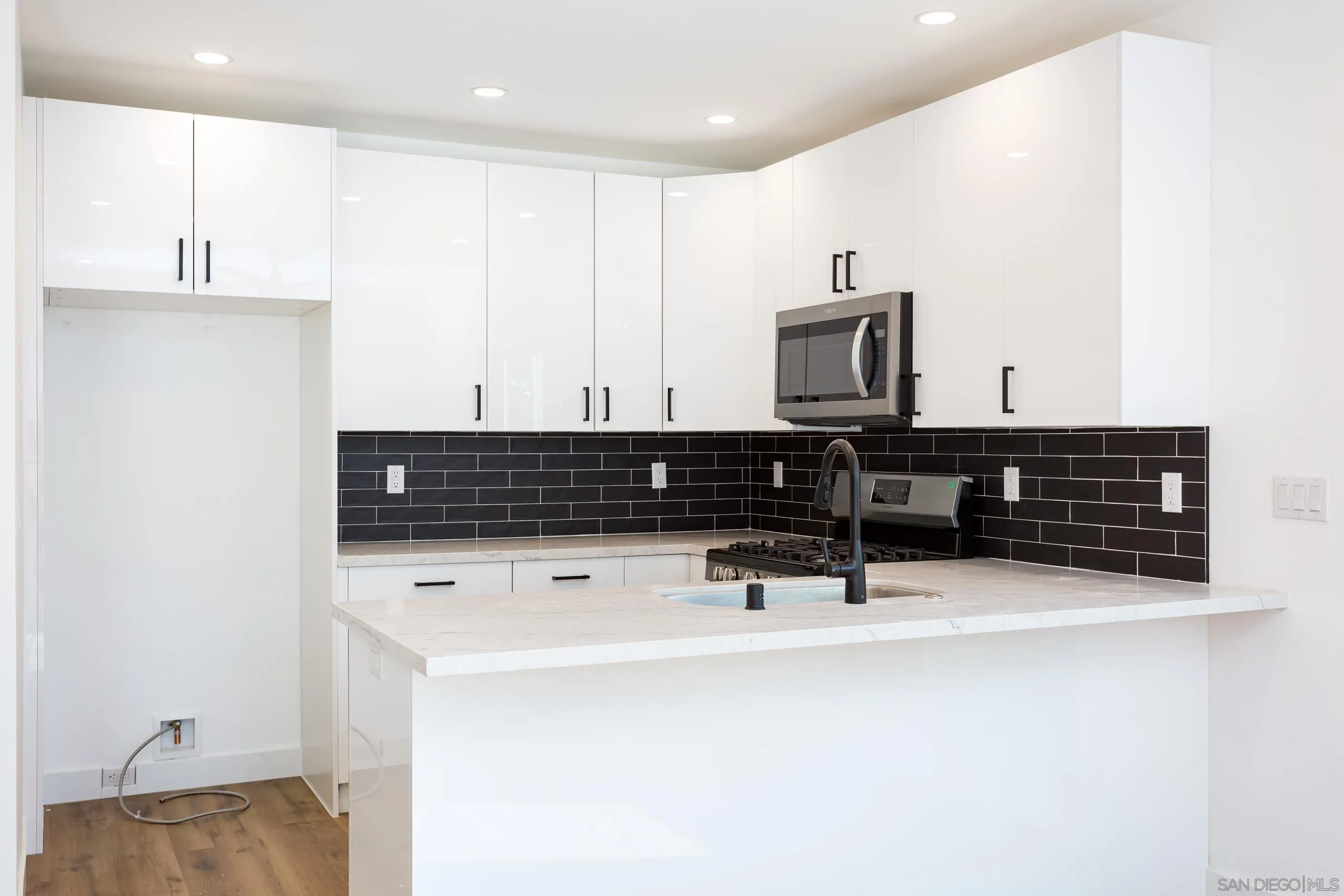 5721-23 Campanile Way San Diego, CA 92115 - Photo 8 of 59 a kitchen with stainless steel appliances a sink and a refrigerator