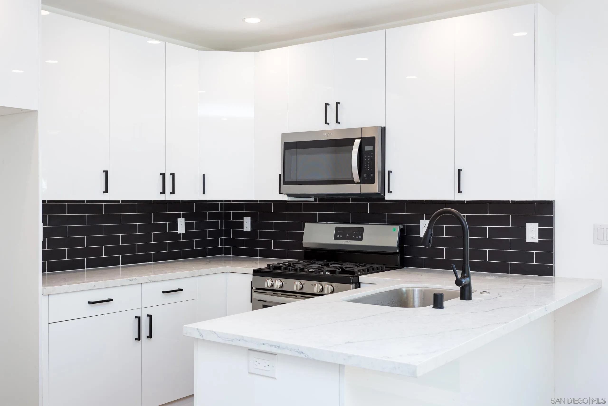 5721-23 Campanile Way San Diego, CA 92115 - Photo 9 of 59 a kitchen with granite countertop a sink and a stove