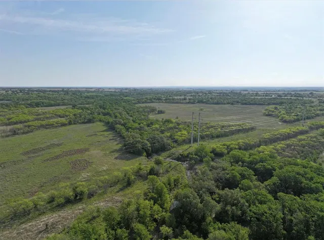 a view of a field with an ocean