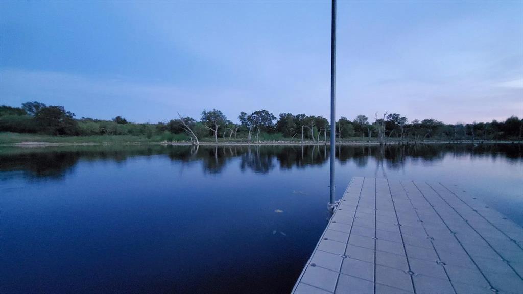 0 Co Road Gorman, TX 76454 - Photo 21 of 25 a body of water with a building in the background