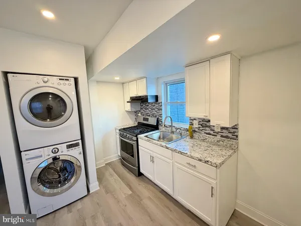 a kitchen with a stove top oven sink and cabinets