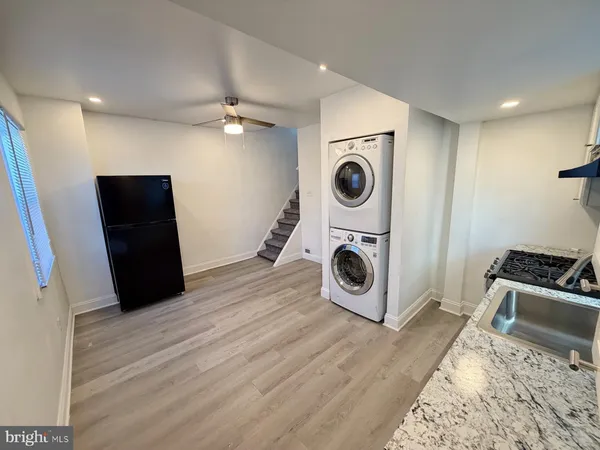 a view of a storage and utility room with a washer dryer