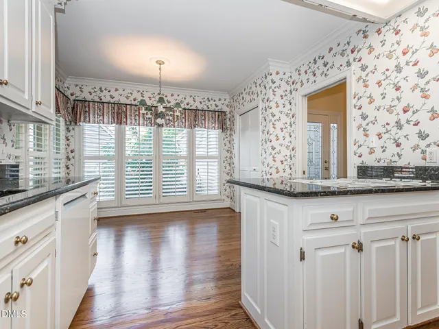 a view of a kitchen with granite countertop cabinets and wooden floor
