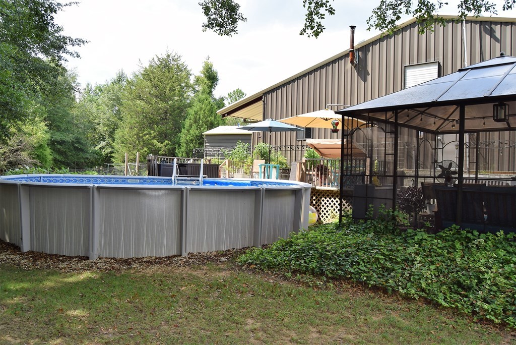 1604 Sandy Point Road Knoxville, GA 31050 - Photo 22 of 36 a backyard of a house with lots of green space