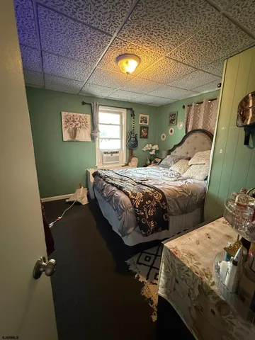 a bedroom with two beds and a window