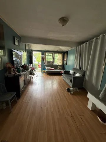 a view of a livingroom with lounge chair and a window