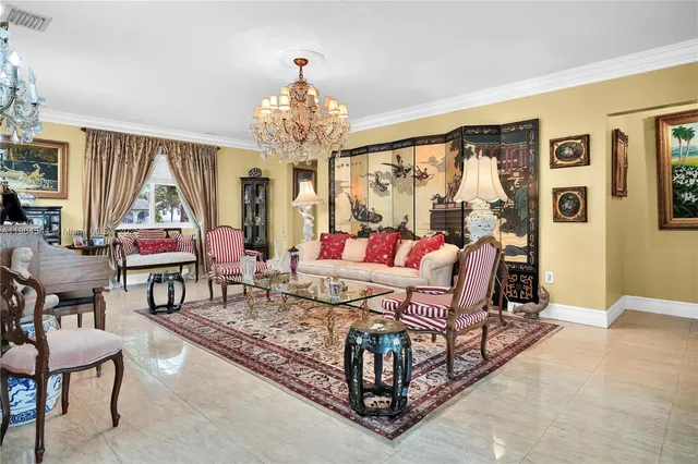 a living room with furniture and a chandelier