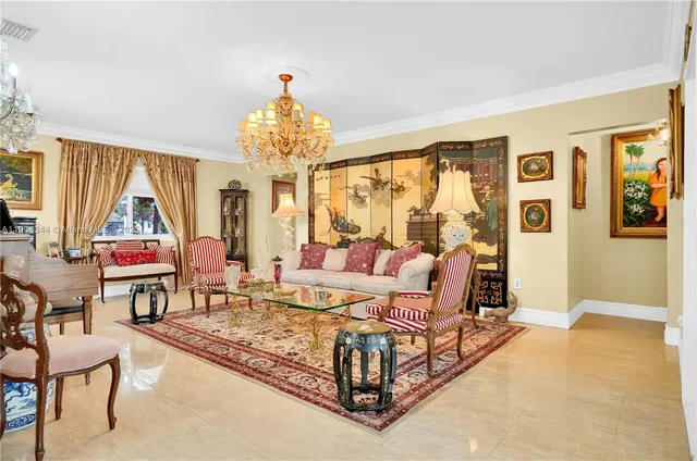 a living room with furniture and a chandelier