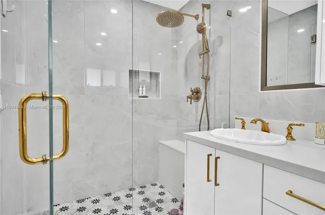 a bathroom with a sink vanity and shower