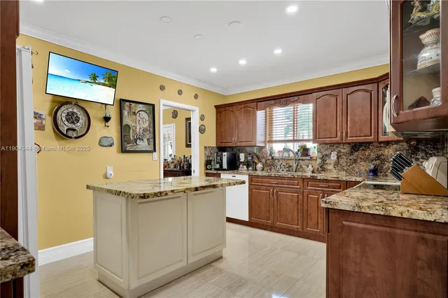 a kitchen with stainless steel appliances granite countertop a stove and a sink