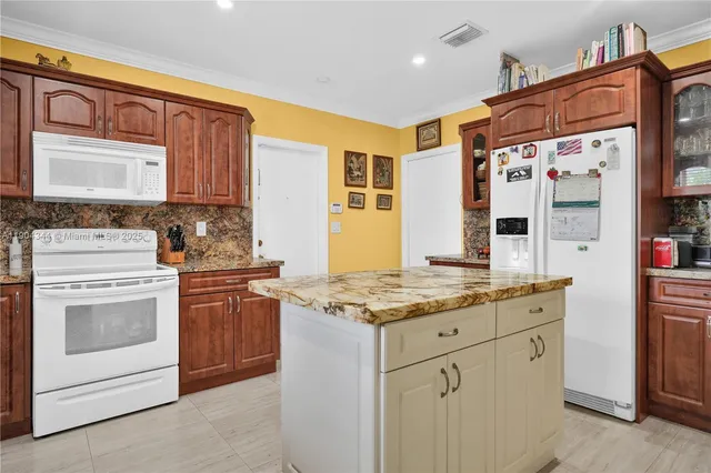 a kitchen with stainless steel appliances granite countertop a stove sink and cabinets