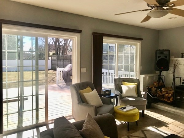 11 Vanness Road Weymouth, MA 02191 - Photo 11 of 25 a living room with furniture and a floor to ceiling window