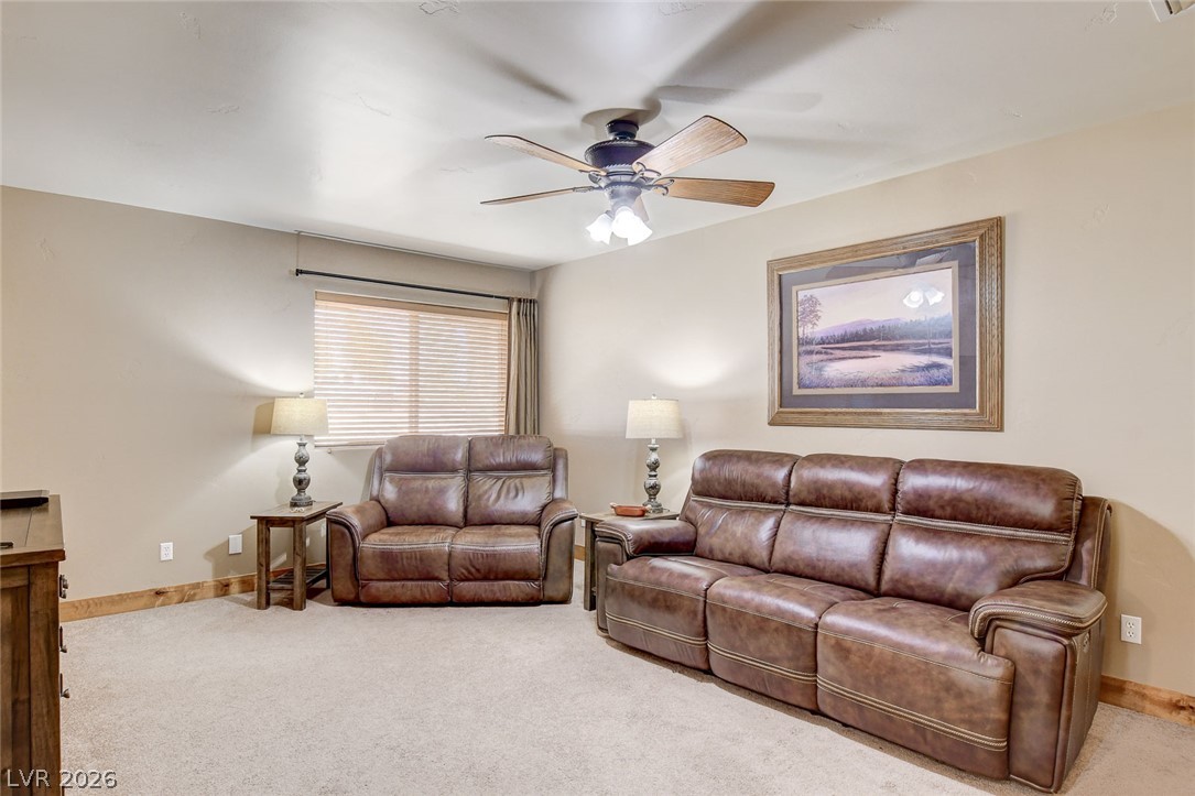 1950 Bowman Road Logandale, NV 89021 - Photo 25 of 81 A versatile living area or bedroom features carpeted flooring and a convenient ceiling fan.