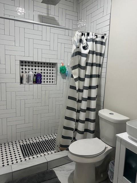 4207 Aztec Drive Dallas, TX 75216 - Photo 13 of 28 a bathroom with a toilet and a shower