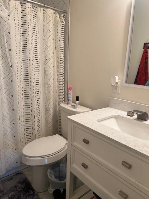 4207 Aztec Drive Dallas, TX 75216 - Photo 16 of 28 a bathroom with a sink a toilet and shower curtain