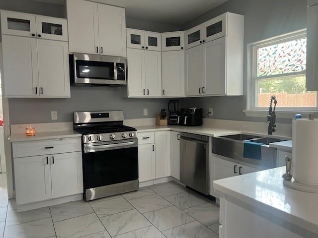 4207 Aztec Drive Dallas, TX 75216 - Photo 7 of 28 a kitchen with stainless steel appliances granite countertop a sink and a stove