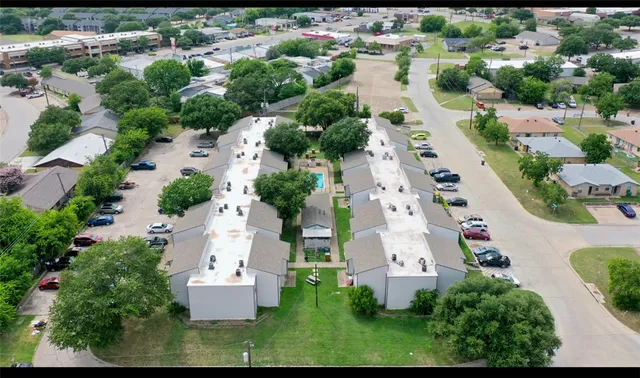 an aerial view of residential houses with outdoor space